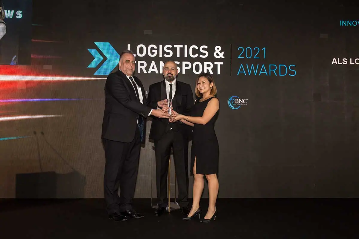 ALS accepting the glass Innovation in Logistics trophy on stage at the Logistics & Transport Awards 2021
