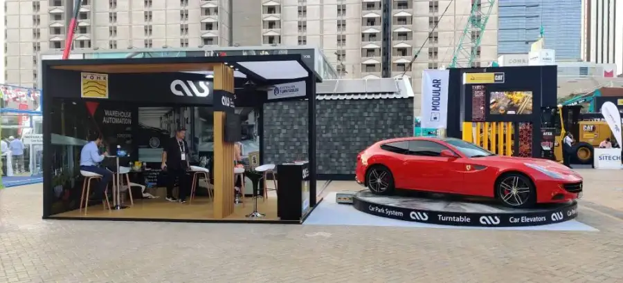 ALS stand with a red sports car on a car park turntable at the Big 5 Show 2022, Dubai World Trade Centre