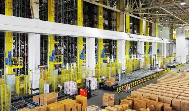 Yellow storage and retrieval machines, conveyors and carton pallets in the Dubai Duty Free automated high-bay warehouse, UAE