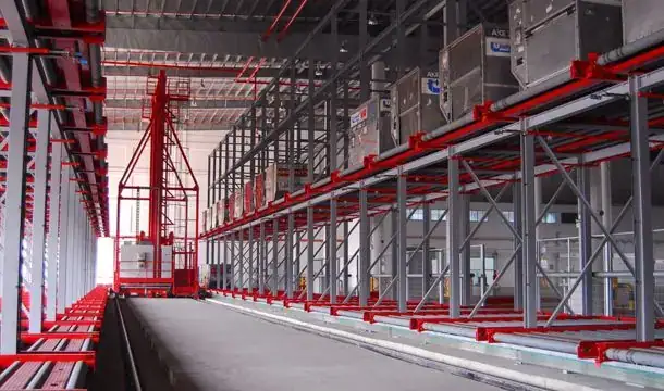 Red elevating transfer vehicle and multi-level ULD racks with cargo containers at Changi International Cargo Terminal, Singapore