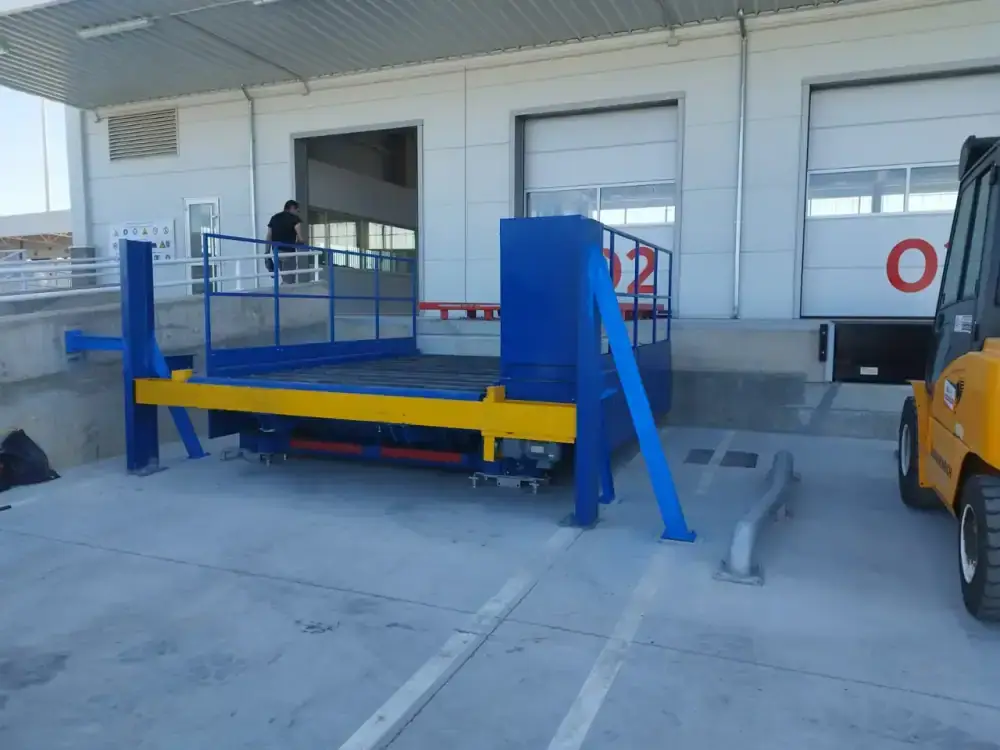 Blue and yellow ULD truck dock with roller deck at a loading bay of Zaragoza International Cargo Terminal, Spain