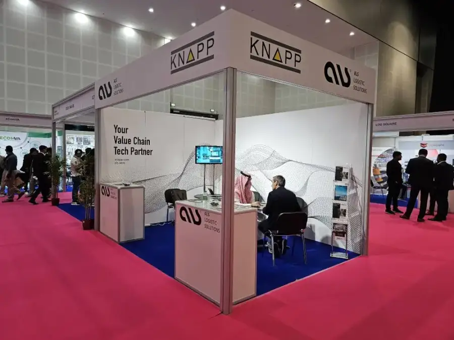 ALS and KNAPP stand with a “Your Value Chain Tech Partner” wall at Seamless Middle East 2023
